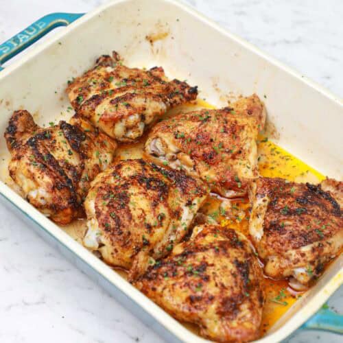 baked frozen chicken thighs in a baking dish.