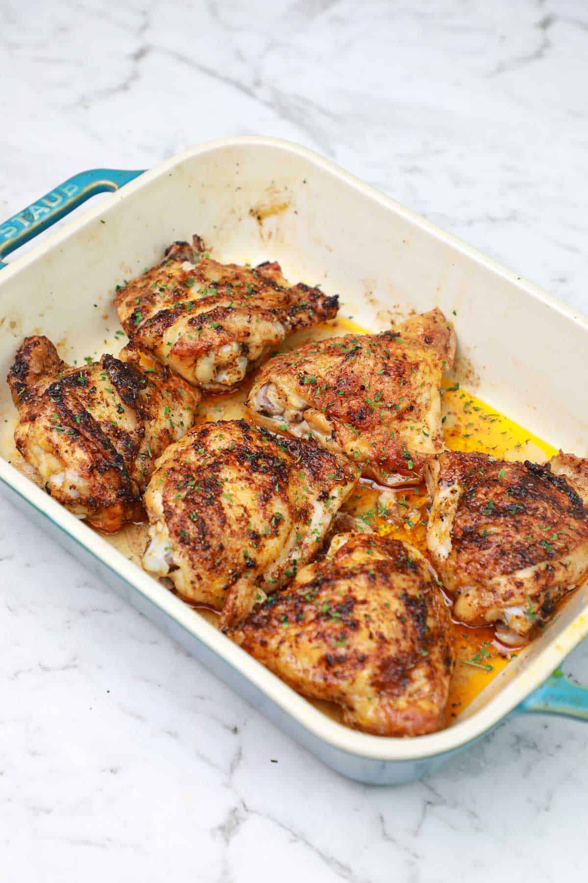 baked frozen chicken thighs in a baking dish.