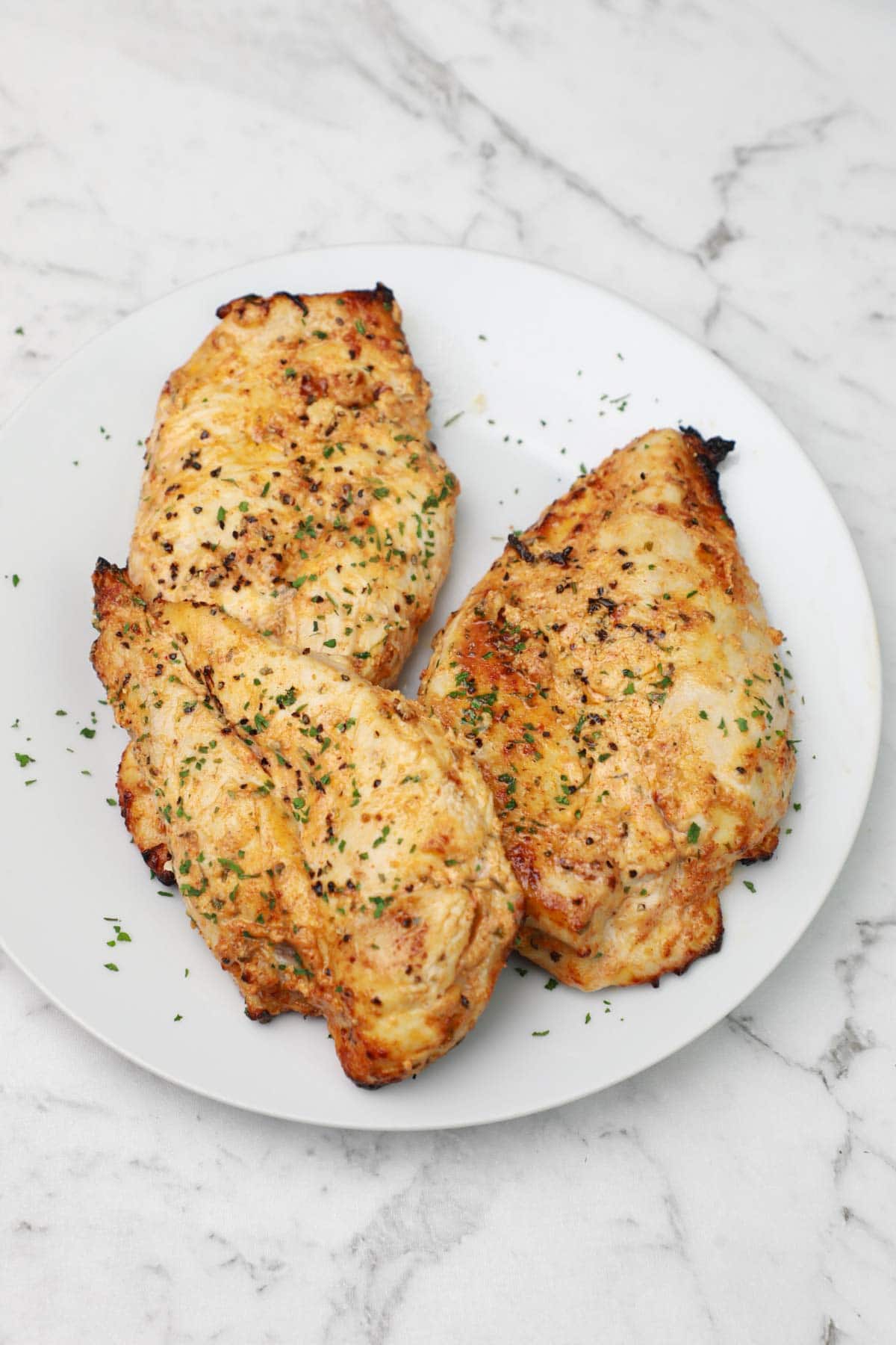 yogurt marinated chicken breast on a plate.